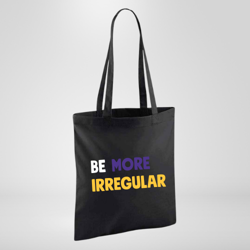 Black tote bag with BE MORE IRREGULAR in white, purple and yellow writing